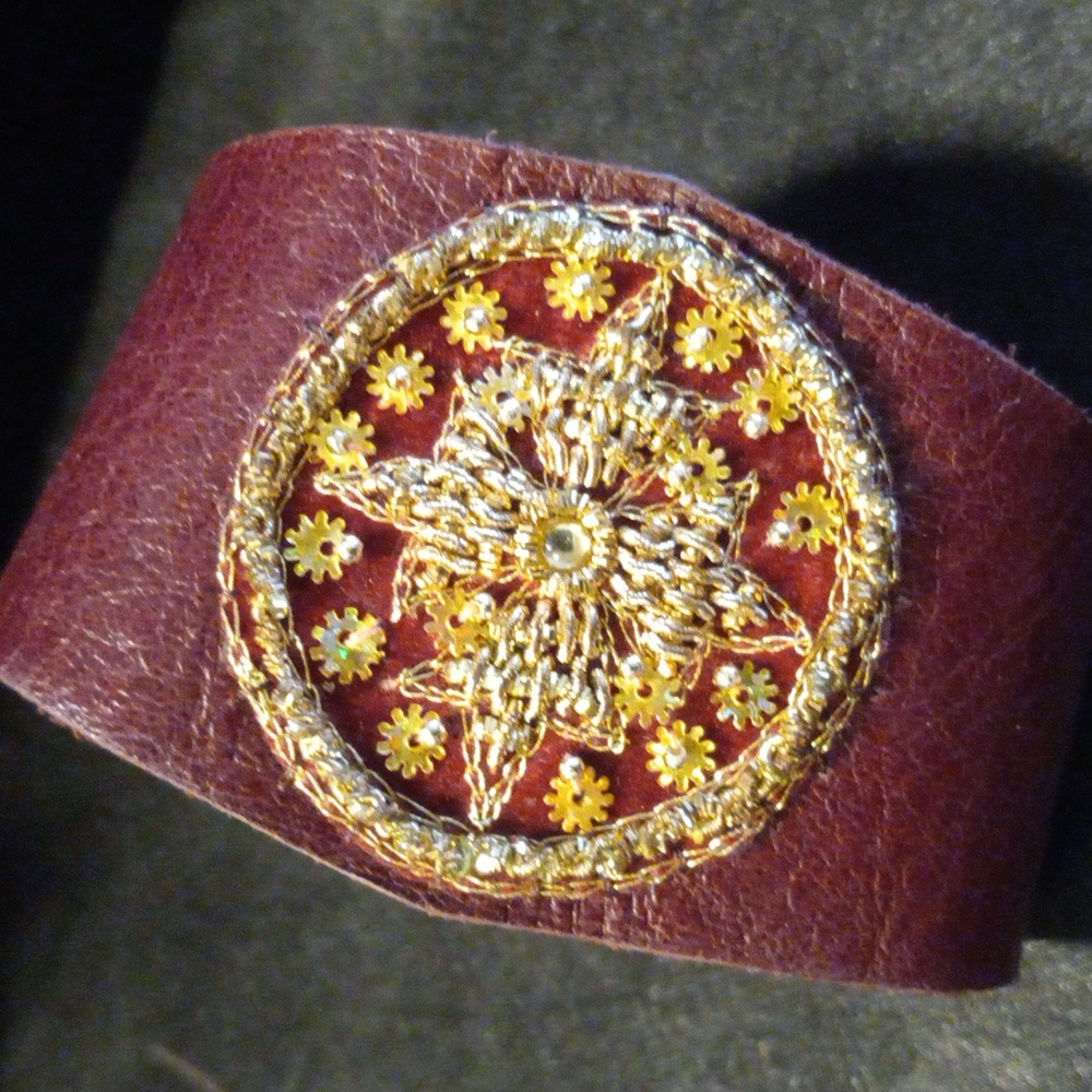 Genuine leather bracelet with hand stitched star design.